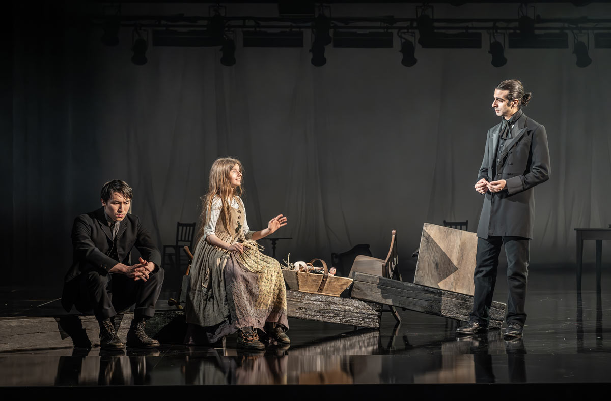 Brandon Grace (Charley Hexam), Ellie-May Sheridan (Jenny Wren) and Scott Karim (Bradley Headstone) in London Tide at the National Theatre. &amp;copy; Marc Brenner